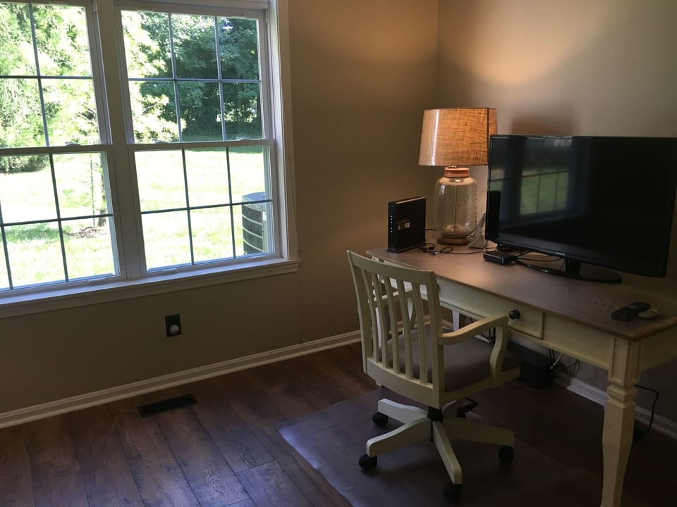 The den includes desk and queen size futon.