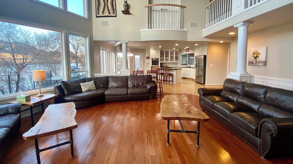 Spacious, open floor plan with many windows in the living room of the main house