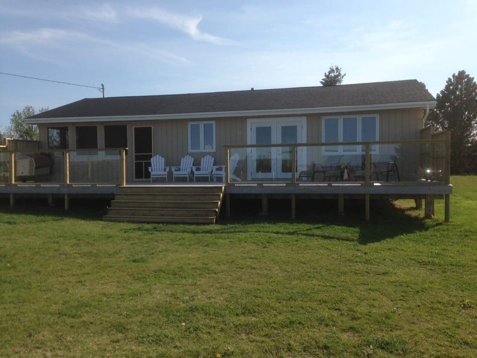 46 foot wide deck, glass railing, lots of chairs, BBQ and amazing ocean view!