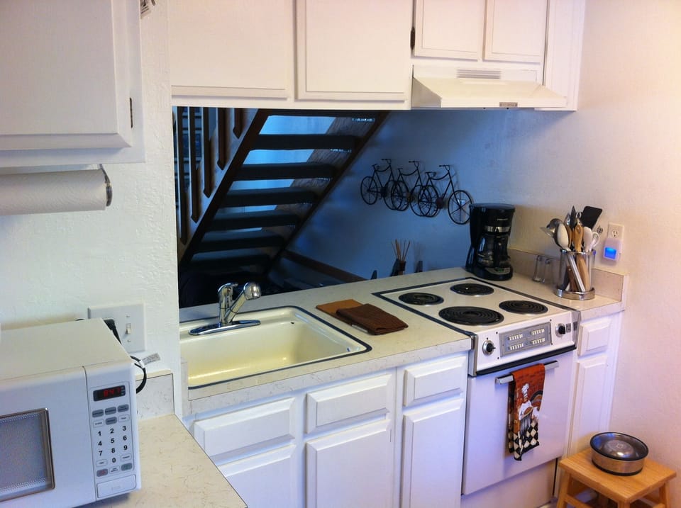 Stove, microwave, auto coffee maker, pots, pans, plenty of dishes and utensils!