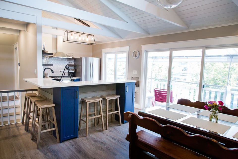 Two sets of sliding-glass doors along the front to the front porch with awning.