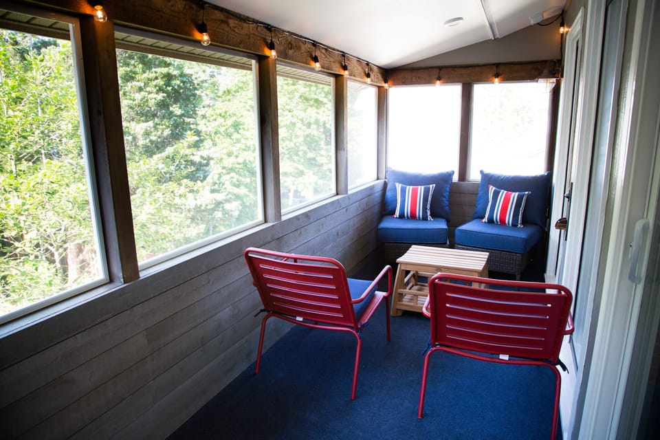 2nd floor porch is breezy & bug-free w/ dining set (not shown) & lounging area.