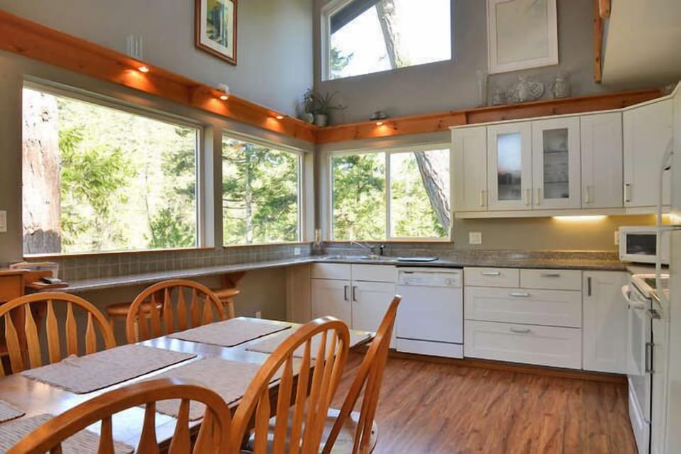 The fully equipped kitchen seats 6. Enjoy water views while cooking!