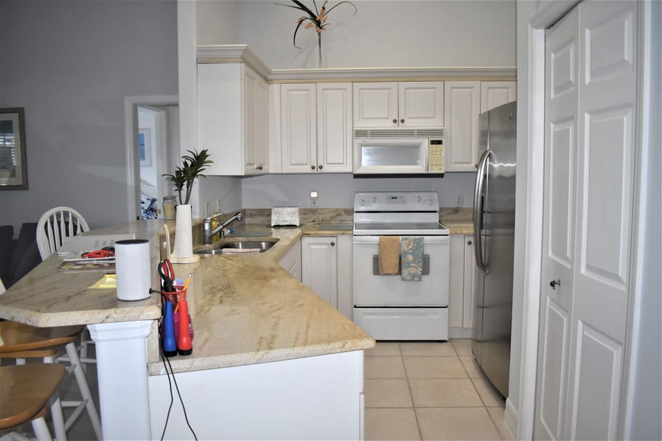 Kitchen with microwave, dishwasher & pantry