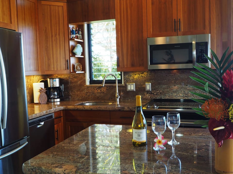 Stainless appliances, custom cabinets, granite counters, ample dishes & cookware