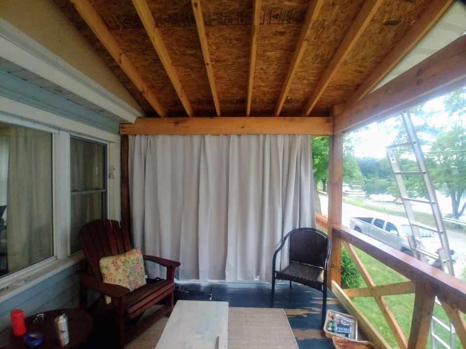 Seating on the deck includes wrought iron  table and wicker couch set.