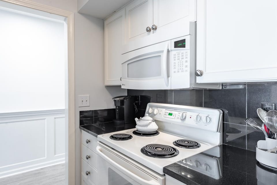 Electric range Keurig coffee maker and microwave.