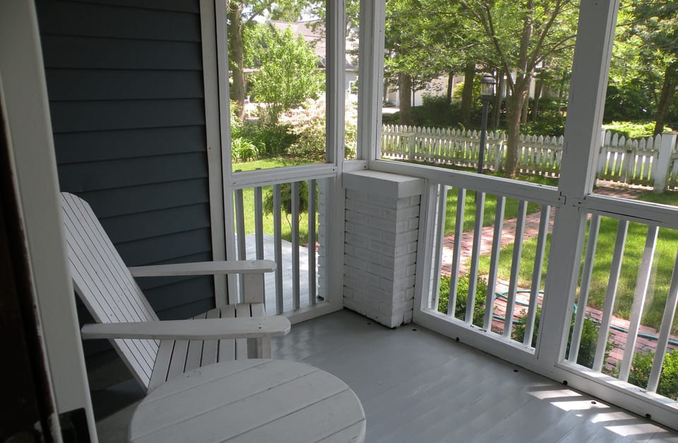 the screened in porch overlooks the front yard
