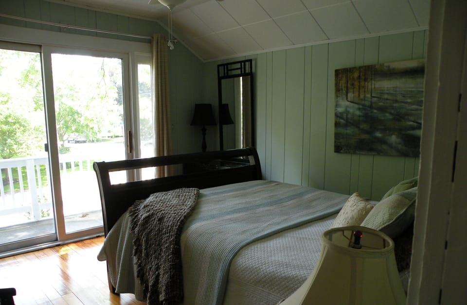 The master bedroom has a queen bed, sliding doors and an Asian decor.