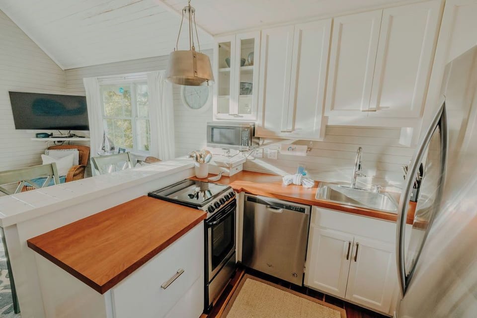 Kitchen with oven, microwave, coffee maker, fridge & dishwasher. 