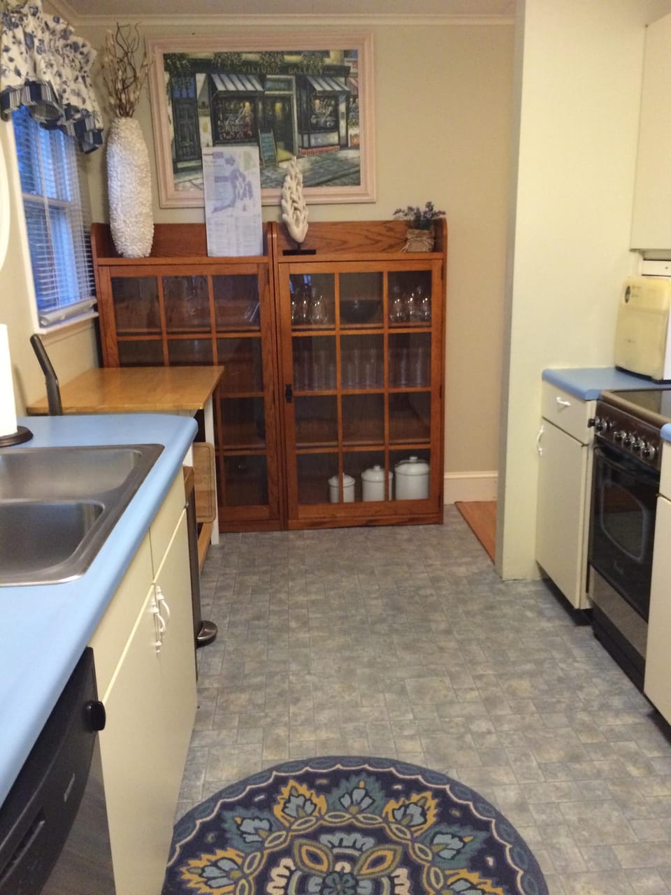 Kitchen stocked with basic cookware, service ware, plates, utensils, glasses
