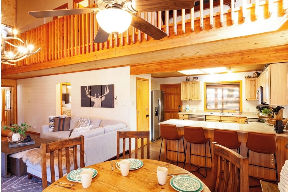 Cozy up in your airy loft-style retreat with warm wood tones, a fully stocked kitchen, and open living space perfect for making memories together.