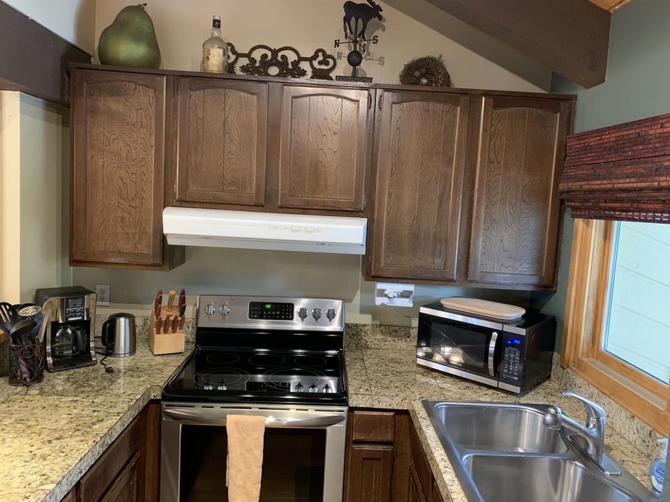 Stocked Kitchen with stainless appliances and granite counters. 
