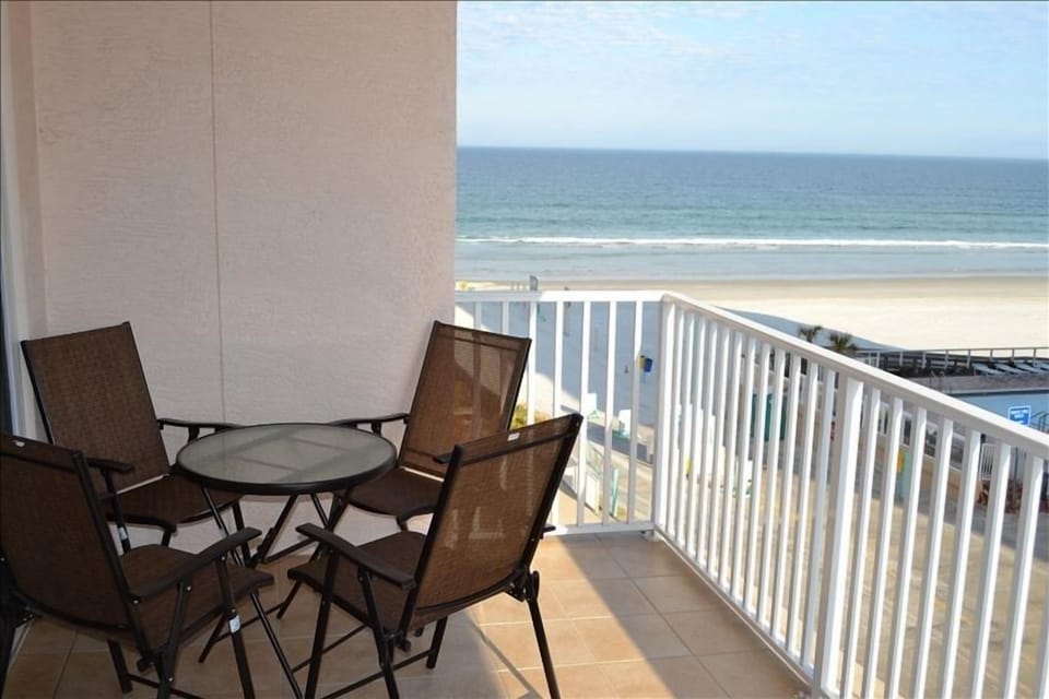 4 chairs and 2 lounge chairs on balcony 