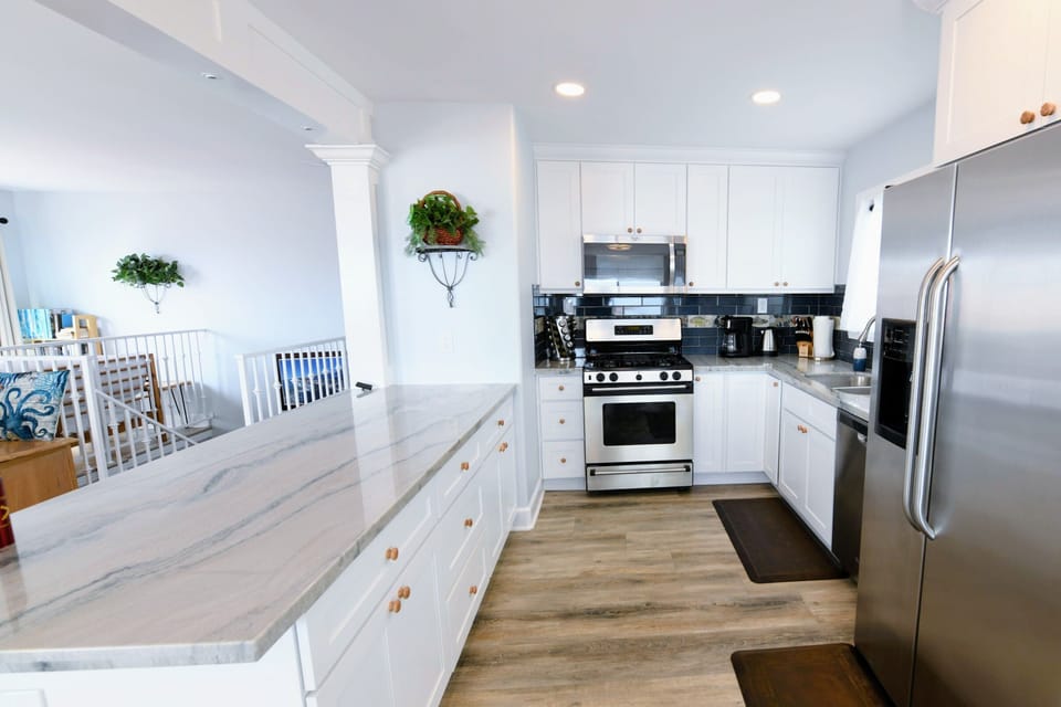 Large peninsula in kitchen with stainless steel appliances 