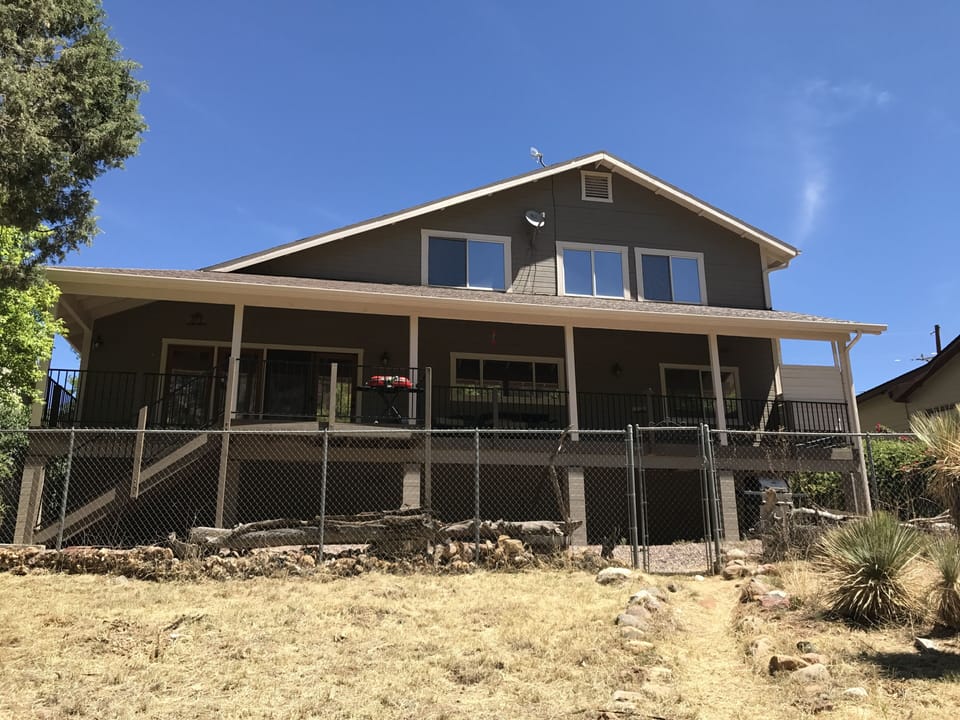 A relaxing covered back deck with a fully fenced yard and gas grill!