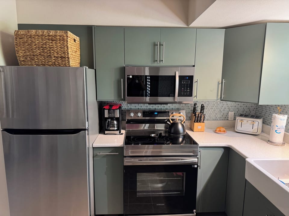 Refrigerator with icemaker. Large microwave and full stove/oven. Lots of counter