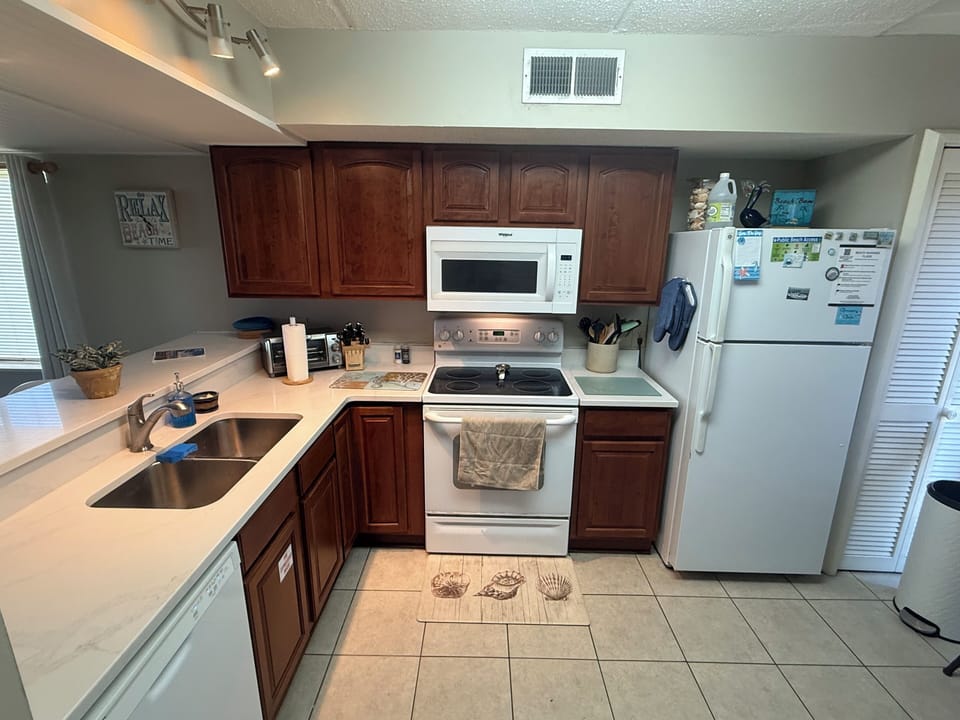 Enjoy meals in our fully stocked kitchen with new quartz countertops.