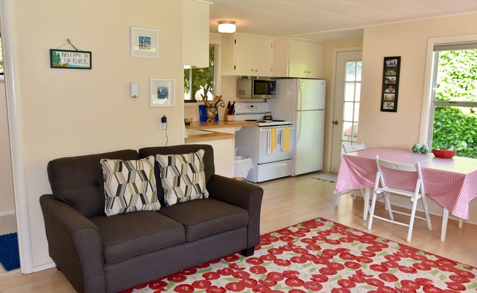The living room flows into the well-equipped kitchen with a cozy dining area