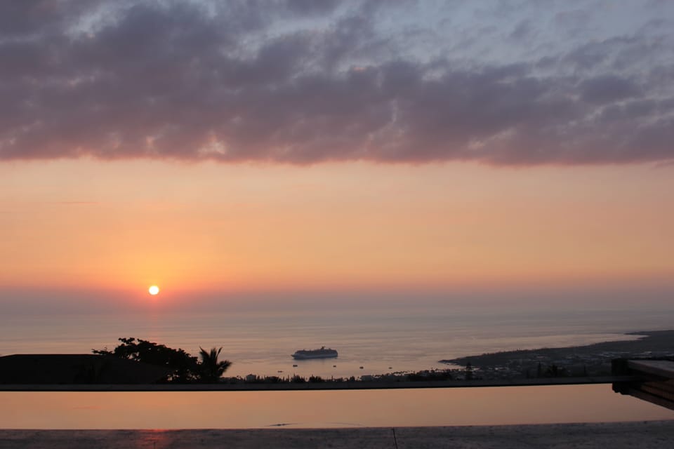 Sunset view over infinity edge salt water pool.