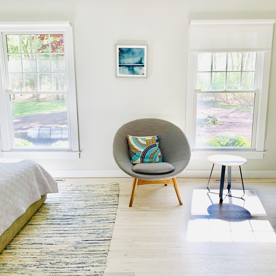 Spacious, stylish primary bedroom with large windows