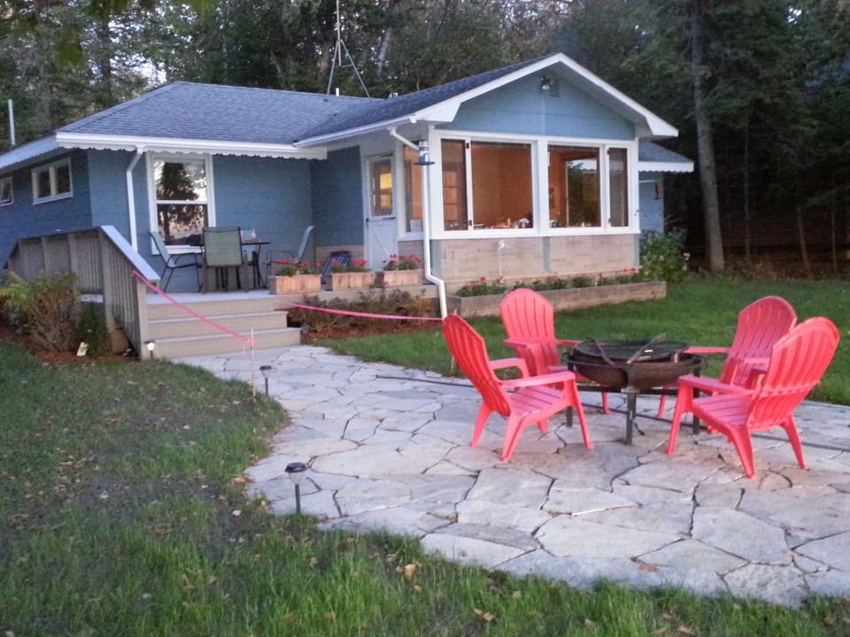 Flagstone patio and new Trex deck with furniture and solar lights for the night.
