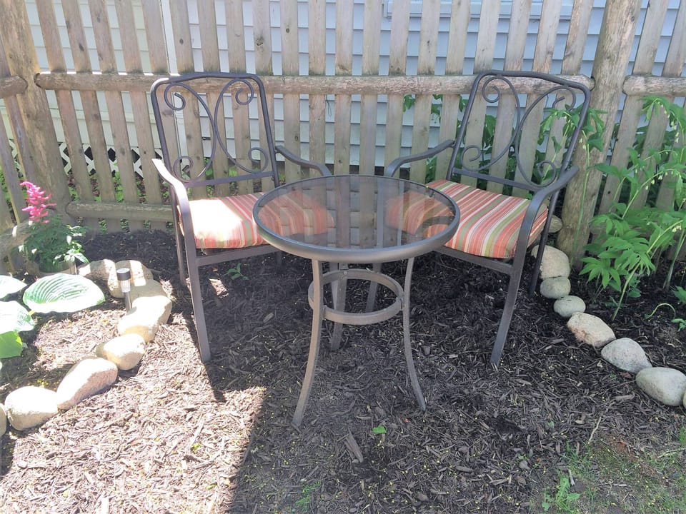 Bistro seating outside in addition to the larger patio table.