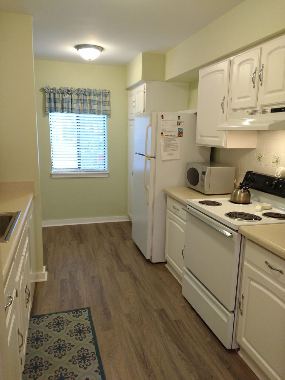 Kitchen with microwave, coffee maker, dishwasher, pantry