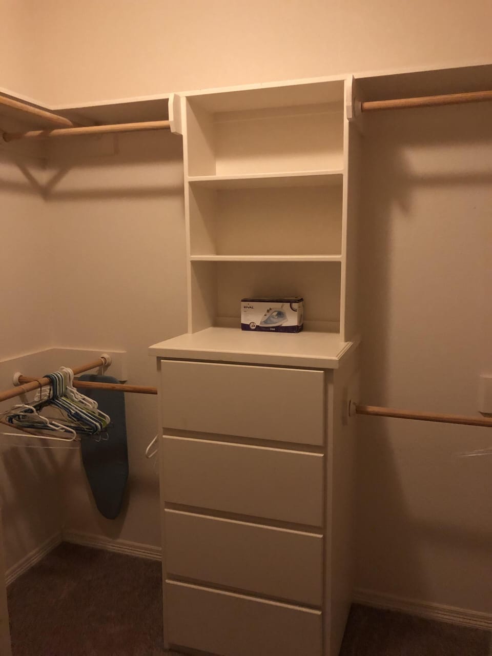 Master closet with iron and ironing board. 