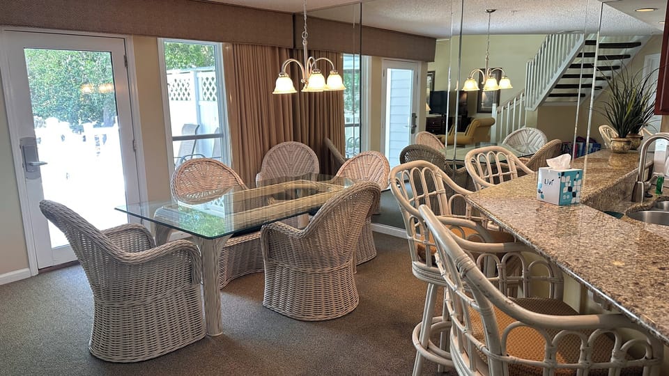 Dining area w/6 chairs. Overlooks back deck and pool.