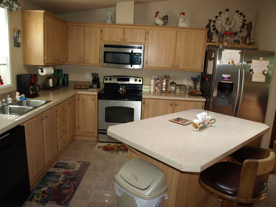 View of the kitchen stove and refrigerator.
