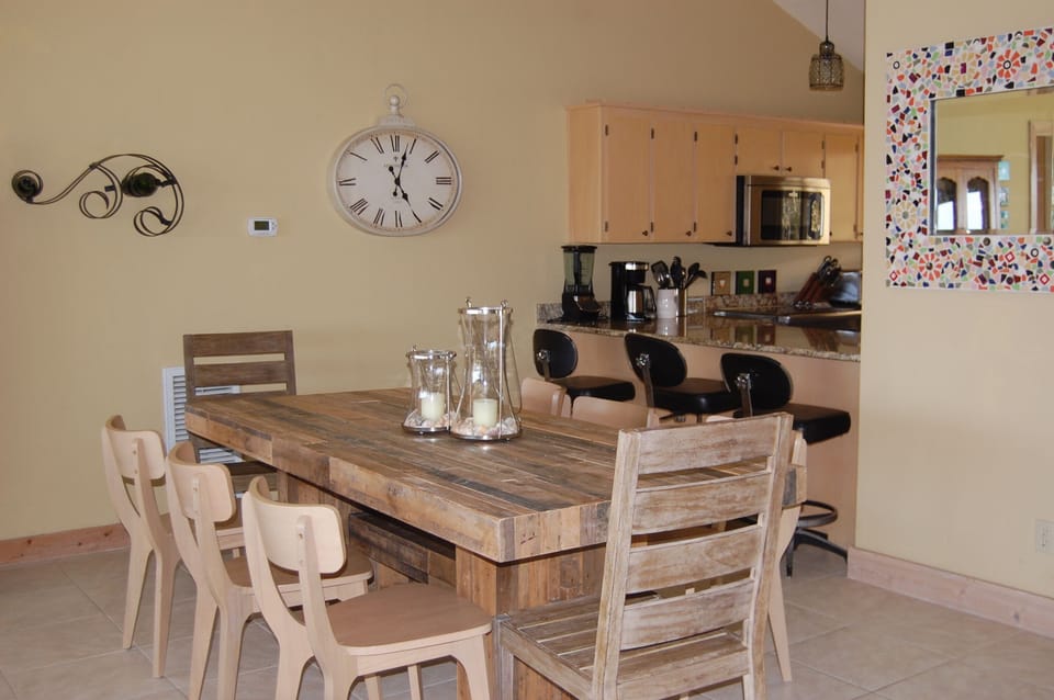 Dining table seats (8).  (3) additional bar stools at kitchen counter