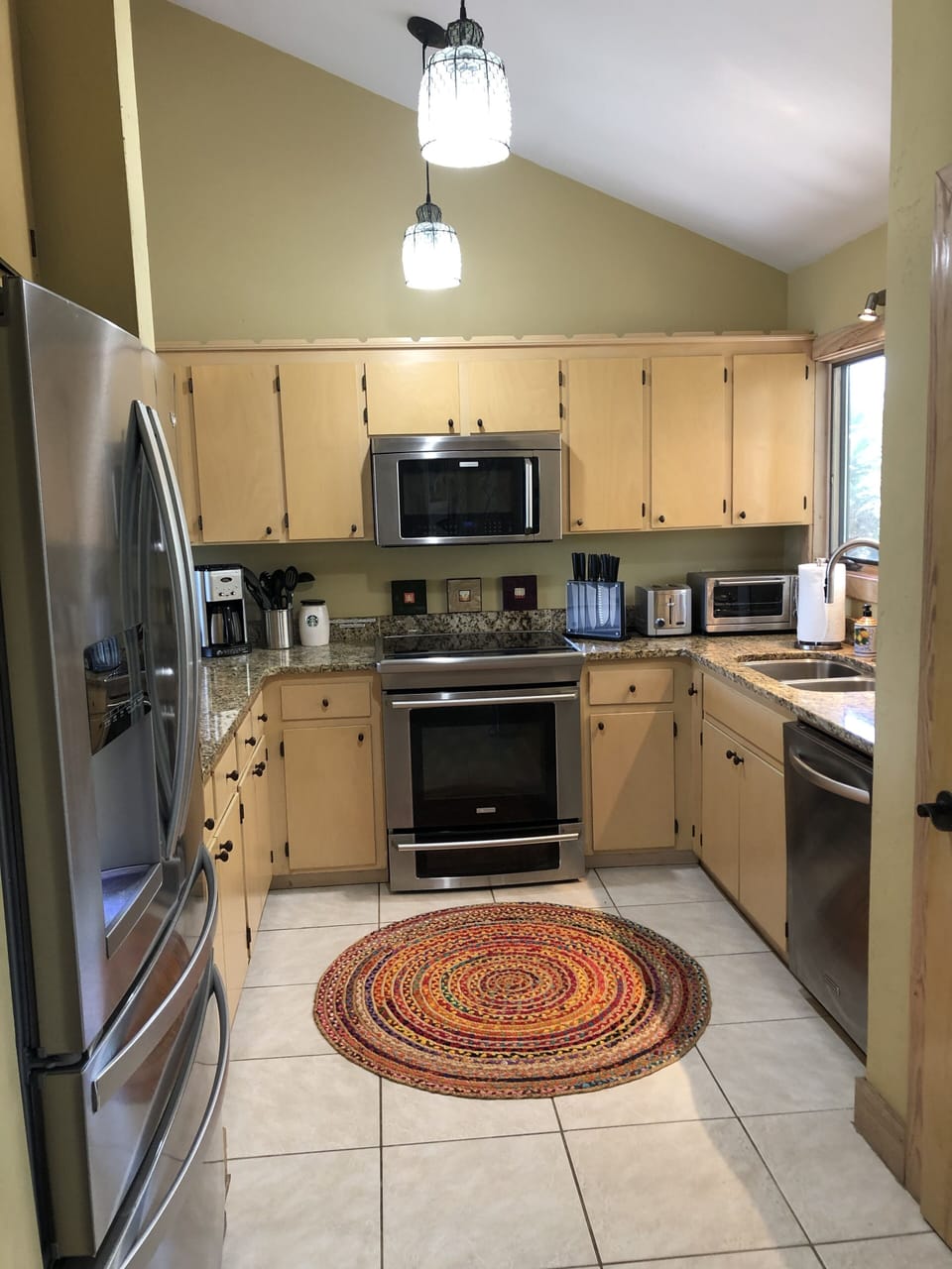 Cook's kitchen has stainless appliances, granite counter tops, and food pantry.