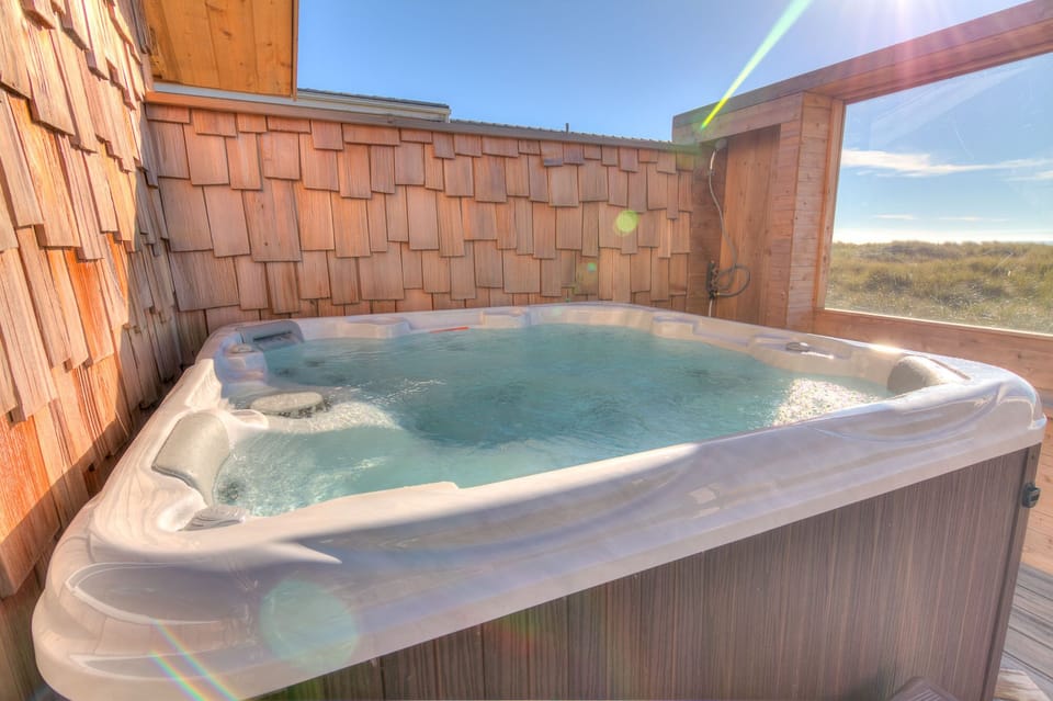 The hot tub is ocean front with a wind block for extra comfort!