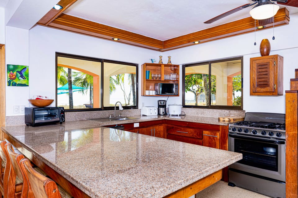 Full Kitchen, Beach view .Rich Hardwoods and Granite Counter tops. 