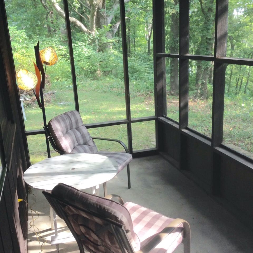 screened-in sitting area off of kitchen with riverview