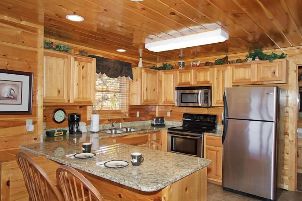 Main Level - Kitchen with Granite Countertops and Stainless Steel Appliances. 