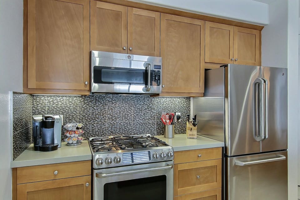 Kitchen with GE Stainless Steel Café Series appliances.