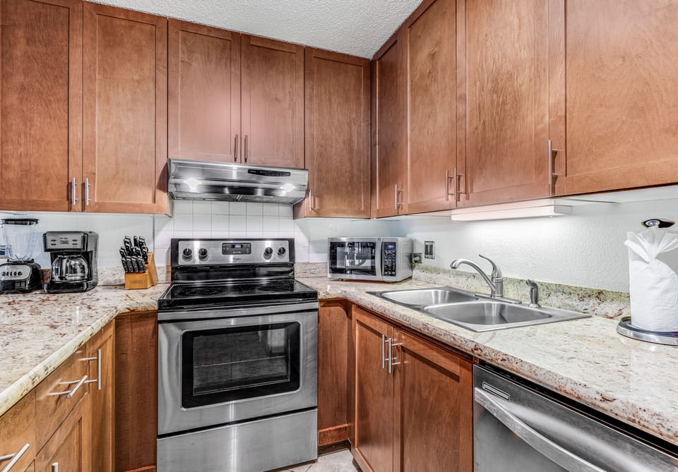 Well-stocked kitchen with stainless steel appliances.