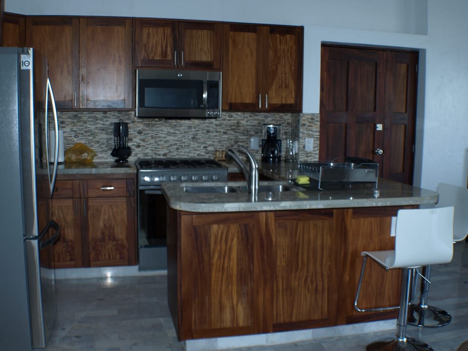 Full kitchen with all amenities, gas range, microwave, refrigerator w/ ice maker