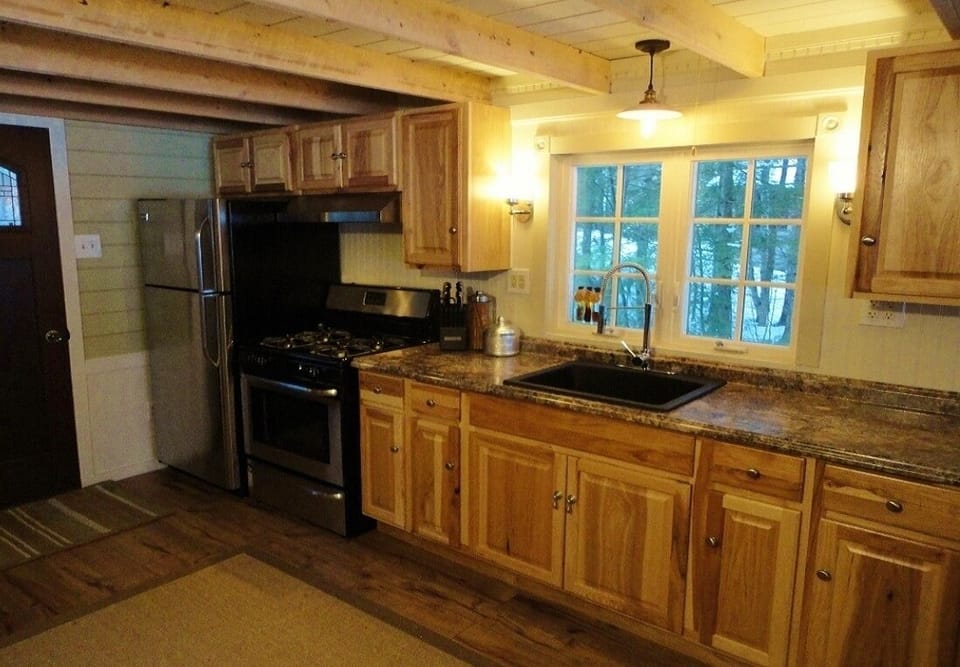 New kitchen with new cabinets, gas range, fridge and counters.