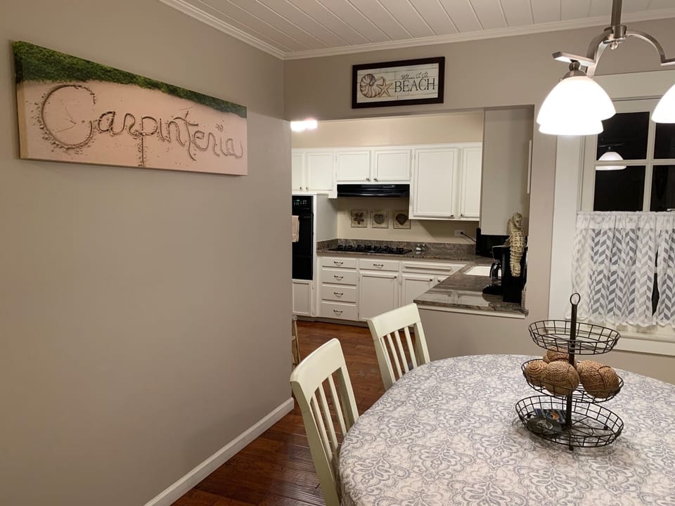 Guests enjoy the 6 person dining area between the living room and the kitchen.