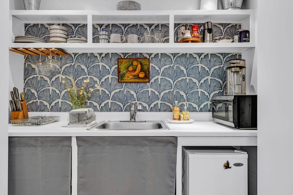 Fully stocked kitchenette with microwave, coffee, mini fridge, and hot plate.