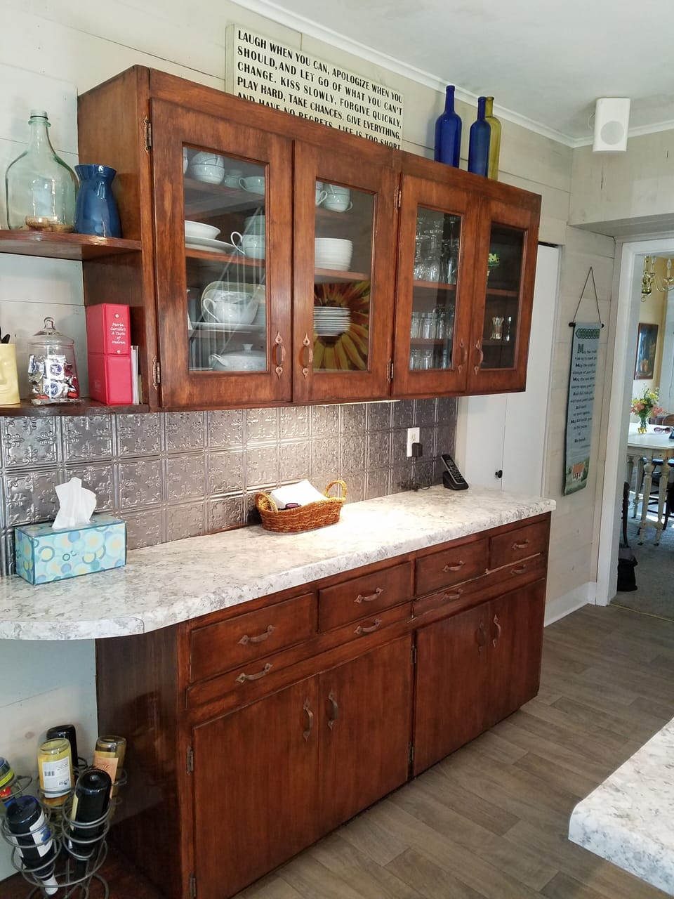cabinet with dishware and glasses in kitchen of main home