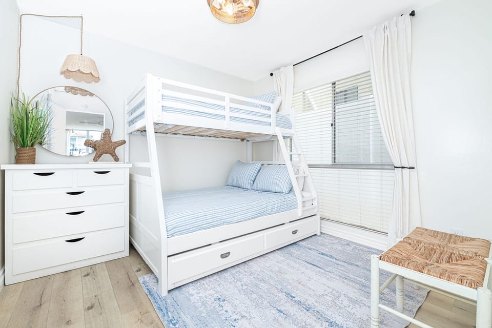 The second guest bedroom is located at the end of the hallway and features a twin-over-full bunk bed with a twin trundle. Due to the moderate climate, this home, like most in the area, does not include central air.
                