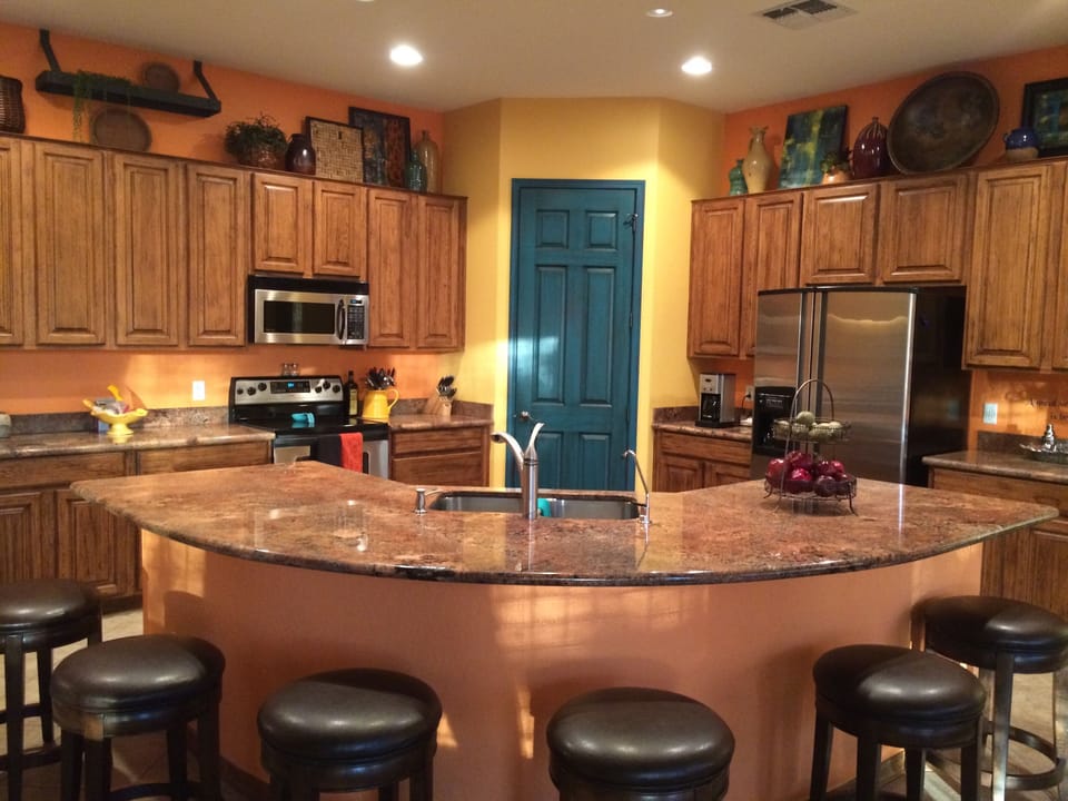 Modern kitchen with stainless steel appliances, granite counter that seats 6..