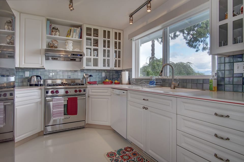 fully equipped kitchen with wolf gas stove cooking top