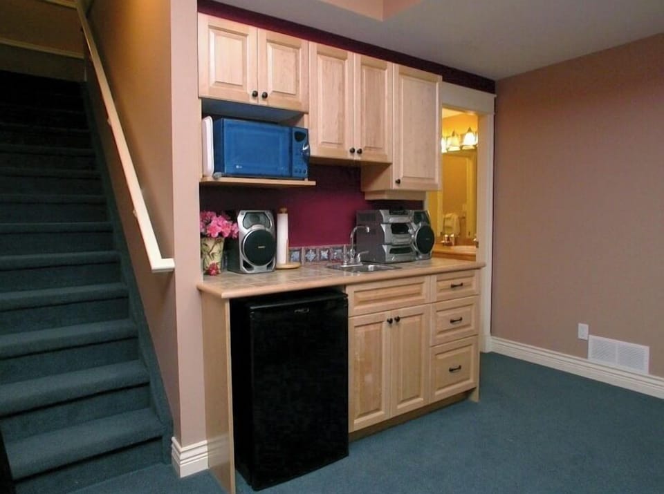 Lower floor den has mini-fridge, microwave, sink. 