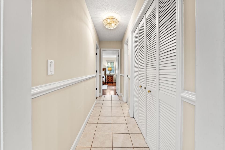 Hallway off foyer leading to laundry and 3 bedrooms