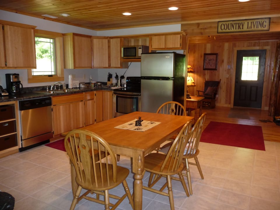 The full service, eat-in kitchen, stocked with utensils and cooking tools.